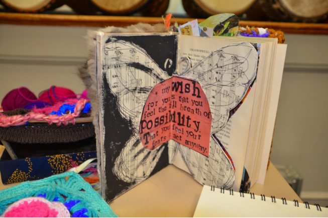 An altered book with a butterfly collage and the words wish and possibility, made in Writing Studio