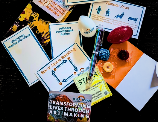 BuildaBridge Arts of Self-Care cards, breathing tools, and kit materials on a table